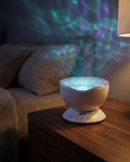 Lumora Aurora Projector in a cozy bedroom